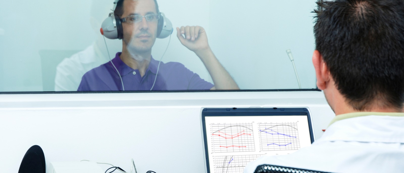 Person wearing earphones with a concerned expression, highlighting the risk of hearing loss — Aanvii Hearing offers free test and consultation.